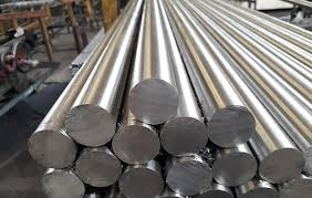 Stainless steel round bars stacked in a manufacturing facility for industrial use